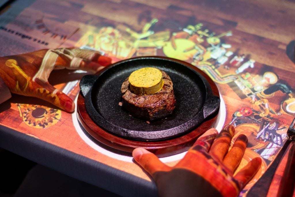 Le Petit Chef & Friends cooking steak and fries.